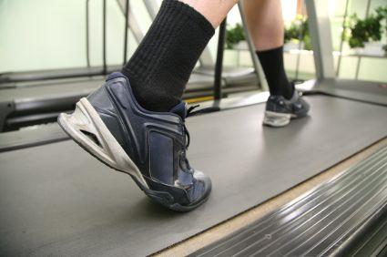 Older patient walking on a treadmill.